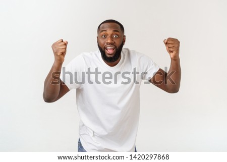 Similar – Cheerful man celebrating his success with a broad smile and raised fist in front of a neutral background