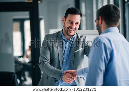 Portrait of cheerful young manager handshake with new employee. 