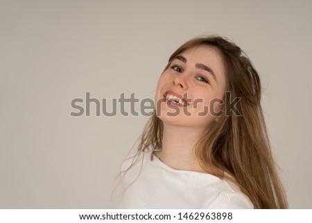 Portrait of cheerful young teenager woman with happy face smiling having fun posing and modeling. Studio shot isolated with copy space. In People, human emotions, youth happiness and beauty concept.