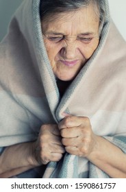 Portrait Of A Cheerless Aged Woman While Feeling Cold. Older  Woman Is Having Flu And Sneezing From Sickness Seasonal Virus Problem. Fever And Cold In Senior People With Influenza Illness