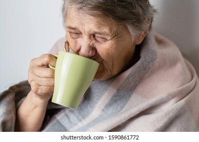 Portrait Of A Cheerless Aged Woman While Feeling Cold. Older  Woman Is Having Flu And Sneezing From Sickness Seasonal Virus Problem. Fever And Cold In Senior People With Influenza Illness