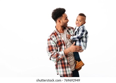 Portrait Of A Cheery Young African Man Playing With His Little Son While Standing And Laughing Isolated Over White Background