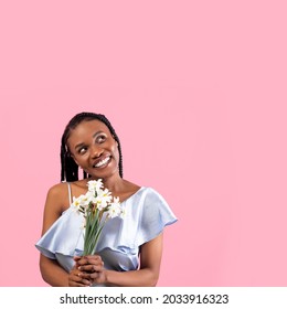 Portrait Of Cheery Young Black Lady With Romantic Bouquet Of Daffodils Over Pink Studio Background, Copy Space. Gorgeous African American Woman Celebrating Birthday, Receiving Flowers As Gift