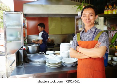 Portrait Of Chef At Asian Street Food Restaurant, Looking At Camera With Arms Crossed. Horizontal Shape, Front View