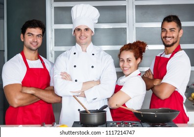 Portrait Of A Chef With His Team Of Restaurant