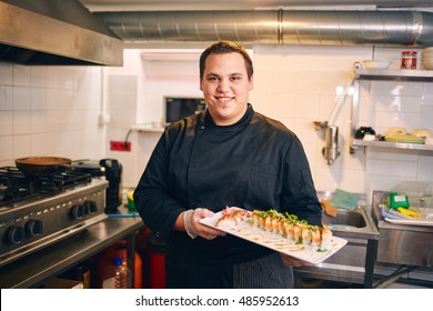 Portrait Of A Chef Making Sushi 