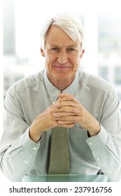 Portrait Of A Chief Executive Officer Sitting At Workplace