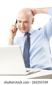 Portrait Of Chief Financial Officer Sitting At Office And Making A Call While Working On Presentation At Laptop. Isolated On White Background. 