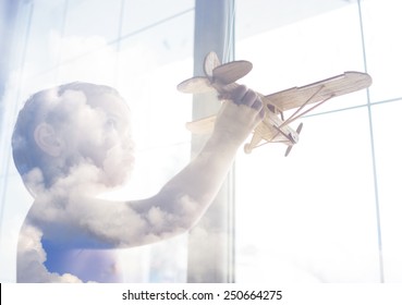 Portrait Of Child With Airplane Traveling Toy In Double Exposure