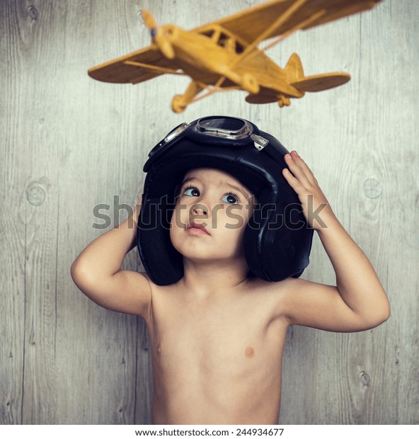 Portrait of child\
with airplane traveling\
toy