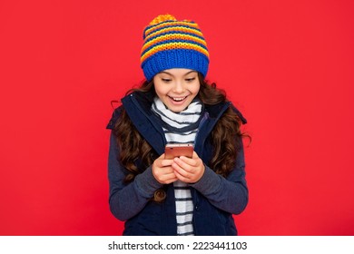 Portrait Of Child Blogging With Phone. Express Positive Emotion. Greeting With Winter Holidays.