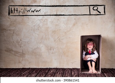 Portrait Of Child Businessman In Cardboard Box. Think Outside The Box Business Concept. Internet Security