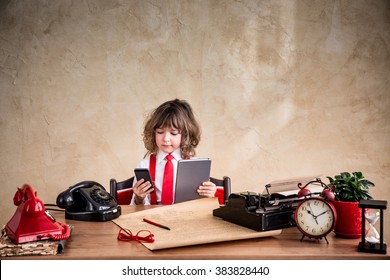 Portrait Of Child Businessman In Office. Kid Holding Gadgets. Communication In Business Concept