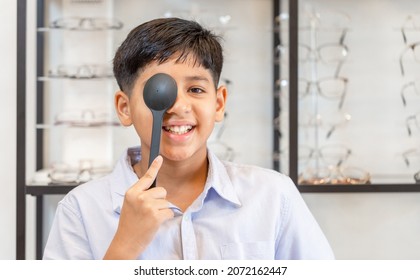 Portrait Of Child Checking Vision At Ophthalmology Clinic, Smiling Indian-thai Boy Choosing Glasses In Optics Store, Eye Test In The Optical Shop