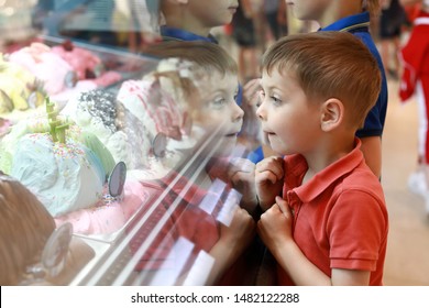 Portrait Of Child Choosing Ice Cream In Cafe