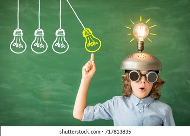 Portrait of child in classroom. Kid with toy virtual reality headset in class. Success, idea and creative concept. Back to school - Powered by Shutterstock