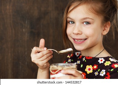 Portrait of a child eating sweet homemade dessert with berries