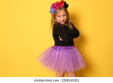 Portrait Of Child Girl In Halloween Costume With Arms Folded Isolated On Yellow Background.