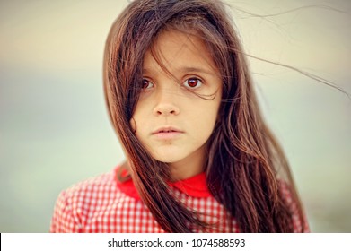 Portrait Of A Child Girl With Sad Expression. Hopeful Concept