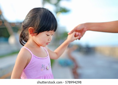 Portrait of child girl walking with mother hold one's hands at seaside, Happy family.