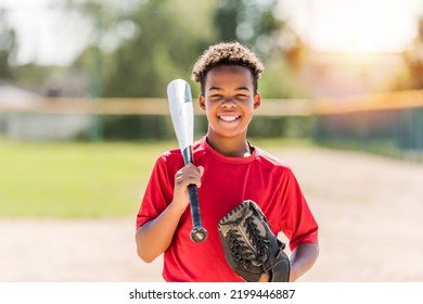 A portrait of child with glove and looking at camera playing baseball - Powered by Shutterstock