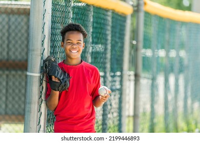 A portrait of child with glove and looking at camera playing baseball - Powered by Shutterstock