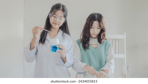 Portrait child kid girl asian young student twoperson team group learning and smile have fun enjoy happy with science lab technology with in  classroom has tubetest Microscope chemicals on table