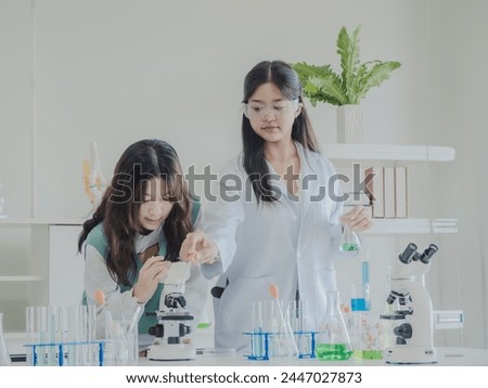 Portrait child kid girl asian young student twoperson team group learning and smile have fun enjoy happy with science lab technology with in  classroom has tubetest Microscope chemicals on table