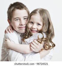 Portrait Of A Child, The Love Of Brother And Sister In His Arms On A White Background