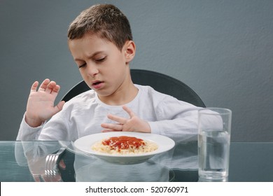 Portrait Of Child With No Appetite In Front Of The Meal. Concept Of Loss Of Appetite