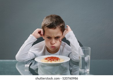 Portrait Of Child With No Appetite In Front Of The Meal. Concept Of Loss Of Appetite