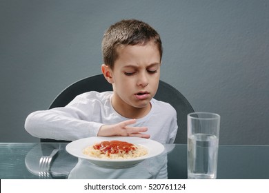 Portrait Of Child With No Appetite In Front Of The Meal. Concept Of Loss Of Appetite