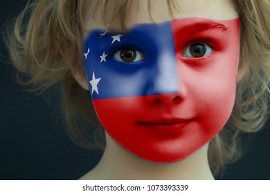 Portrait Of A Child With A Painted Samoa Flag On Her Face, Closeup.