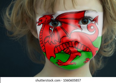 Portrait Of A Child With A Painted Welsh Flag On Her Face, Closeup.