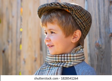Portrait Of A Child With A Smile. Little Boy In A Tweed Hat. Irish Style.