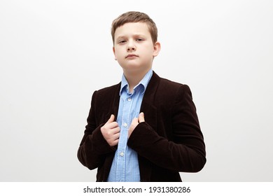 Portrait Of Child In Suit. Handsome Little Boy In A Corduroy Jacket. 11 Years Old Kid