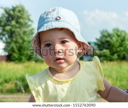 Similar – beautiful baby looking very funny into the the camera