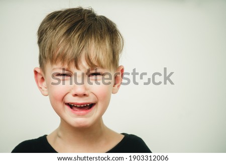portrait of a child with tears in his eyes close-up