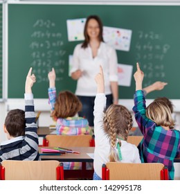 Portrait Of Children Raised Their Hands In The Classroom