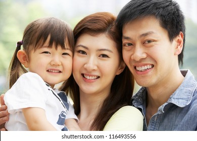 Portrait Of Chinese Family With Daughter In Park