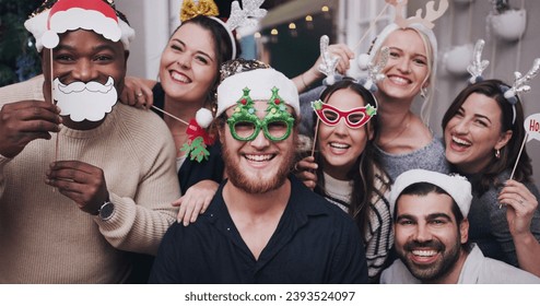 Portrait, Christmas and friends with a man and woman group in a home for a party or celebration together. Diversity, happy and mask with a male and woman friend crown in house for the festive season - Powered by Shutterstock