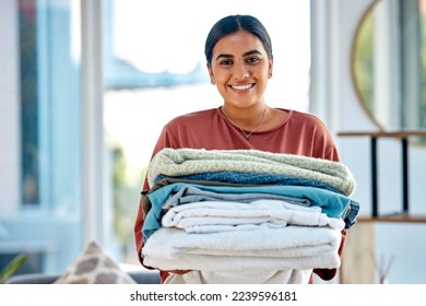 Portrait, cleaning or woman with laundry or happy smile after washing clothes or towels in cleaning services. Hospitality, hotel or face of Indian cleaner working at a airbnb, house or home in Mumbai - Powered by Shutterstock