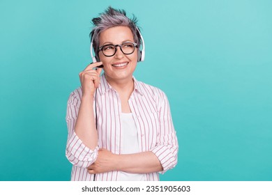 Portrait of clever young lady wear white striped shirt looking empty space minded working with headset isolated on blue color background - Powered by Shutterstock