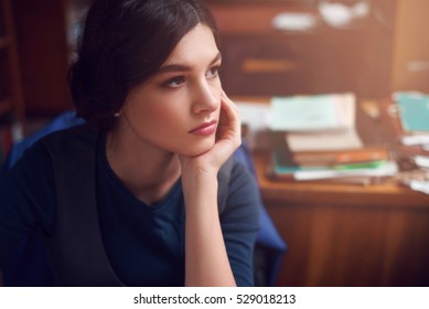 Portrait Of Clever Young Woman Thinking Alone