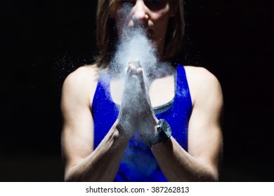 Portrait Of Climber Woman Coating Her Hands In Powder Chalk Magnesium.