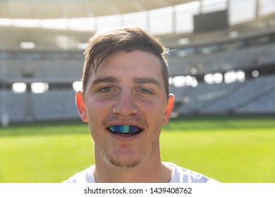 Portrait Close Up Of Caucasian Male Rugby Player With Mouth Guard In Stadium On Sunny Day.