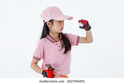 Portrait close up isolated studio shot of little Asian golfer in pink sport athlete uniform and cap with red gloves stand and hold golf ball in hand in front of white background.