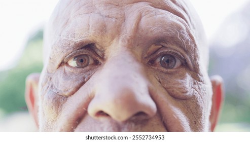 Portrait of close up of senior biracial man opening eyes wide in garden. Healthy, active senior lifestyle. - Powered by Shutterstock