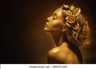 Portrait Closeup Beauty fantasy woman, face in gold paint. Golden shiny skin. Fashion model girl, image goddess. Glamorous crown, wreath roses, jewellery accessories. Professional metallic makeup.