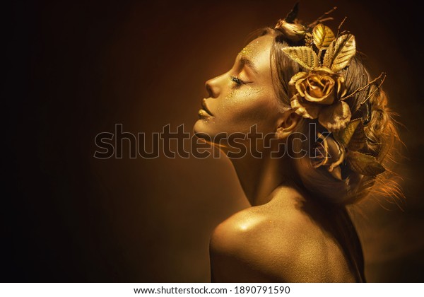 Portrait Closeup Beauty fantasy woman, face in\
gold paint. Golden shiny skin. Fashion model girl, image goddess.\
Glamorous crown, wreath roses, jewellery accessories. Professional\
metallic makeup.